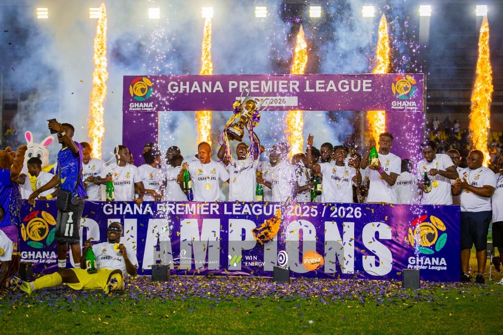 Medeama SC on the champions podium after winning the 2025/26 Ghana Premier League, with stadium, fireworks and confetti behind them